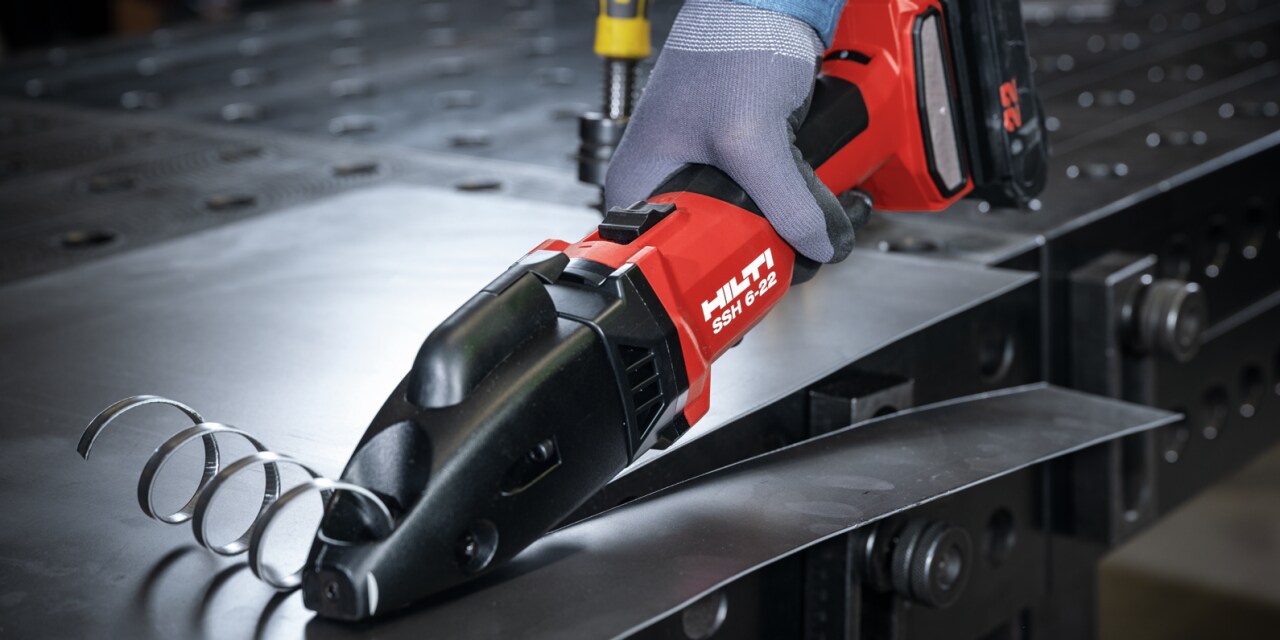 man using metal shear