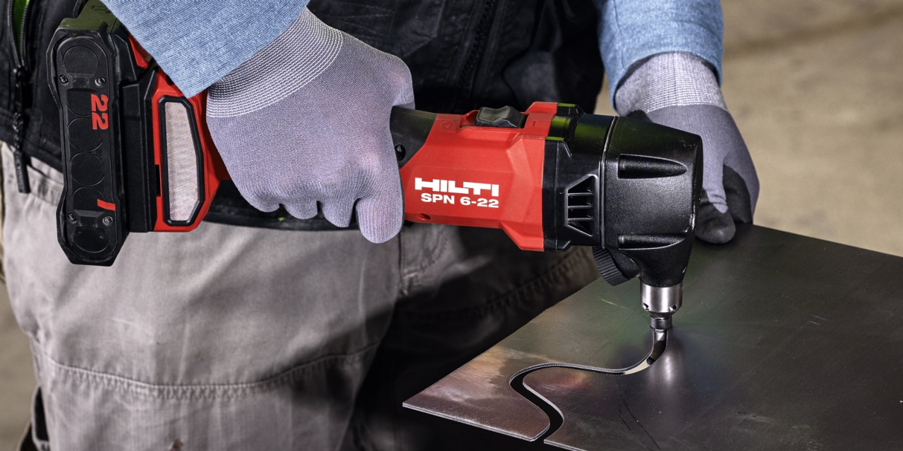 man using cordless nibbler
